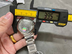 Cartier automatic wristwatch on measurement tools, stainless steel band and gray dial
