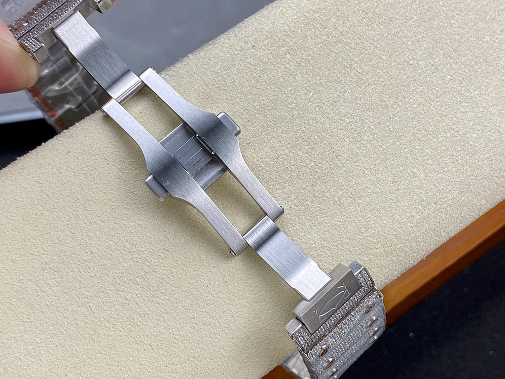 Cartier watch clasp and bracelet links on display, silver-tone metal band