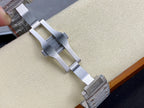 Cartier watch clasp and bracelet links on display, silver-tone metal band