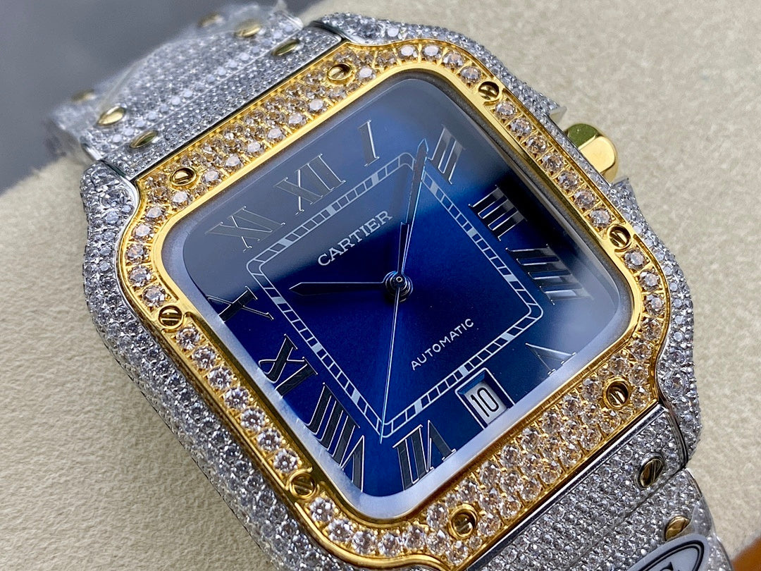 Cartier watch close-up with blue dial, “AUTOMATIC” text, gold bezel rim, gray strap