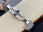 Cartier watch clasp view with gray metal bracelet links and jeweled end pieces