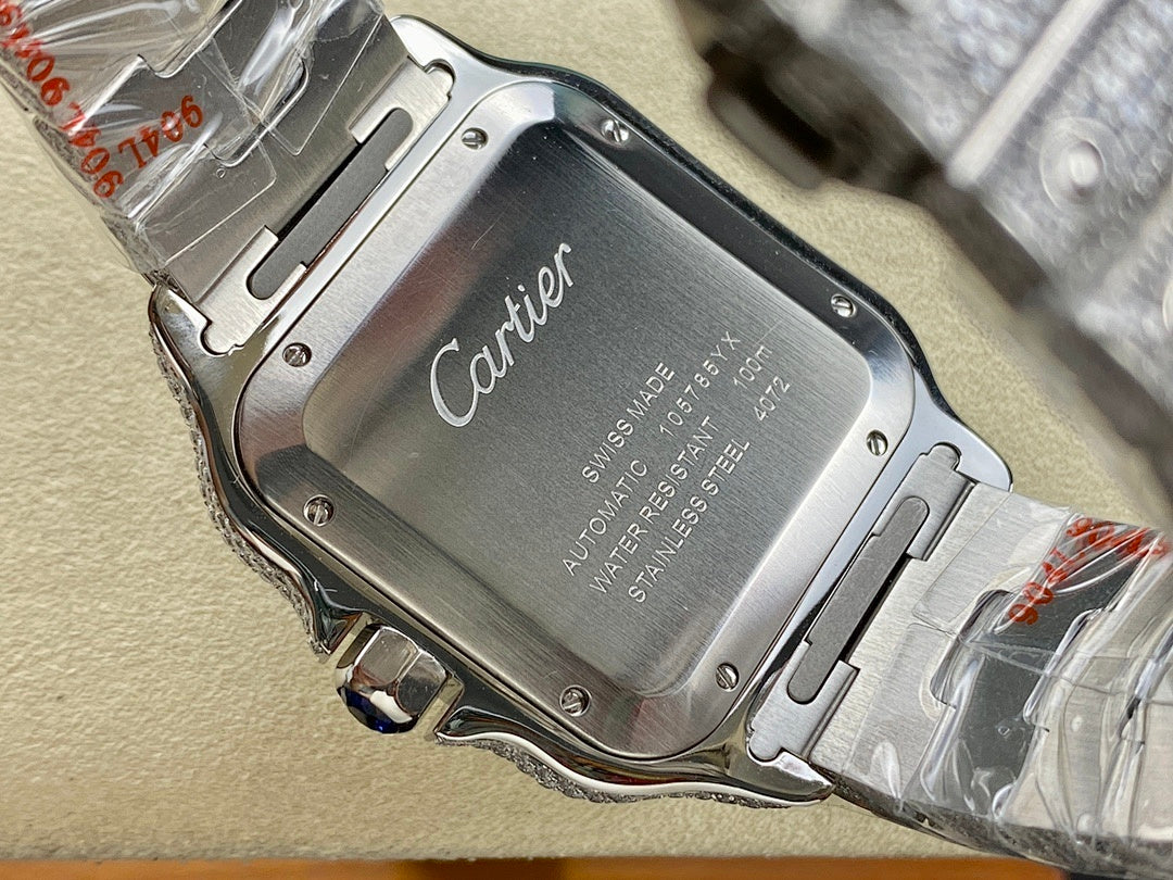 Cartier watch caseback with engraved Cartier logo on silver metal, bracelet visible