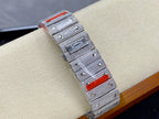 Diamond-studded Cartier watch with red accents on case and metal strap
