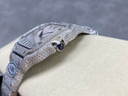 Close-up Cartier watch with black dial detail and blue cabochon on bezel