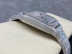 Diamond bezel Cartier watch with striped dial and metal bracelet on cushion