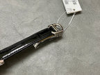 Rectangular wristwatch leather strap with silver-tone clasp hardware, black glossy finish.