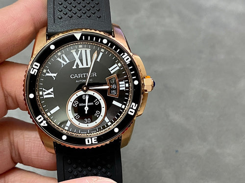 Gold-tone dive watch showing black dial, Roman numerals, and three subdial indicators
