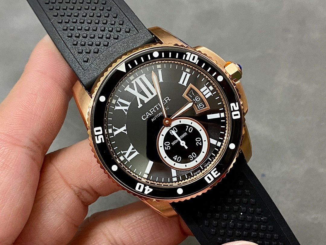 Gold-tone dive watch close-up with black dial, Roman numerals, and subdial window