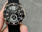 Cartier watch with black dial, Roman numerals, date window, and black rubber strap