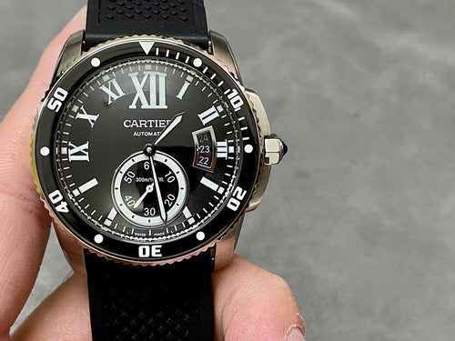 Cartier watch with black dial, Roman numerals, date window, and black rubber strap