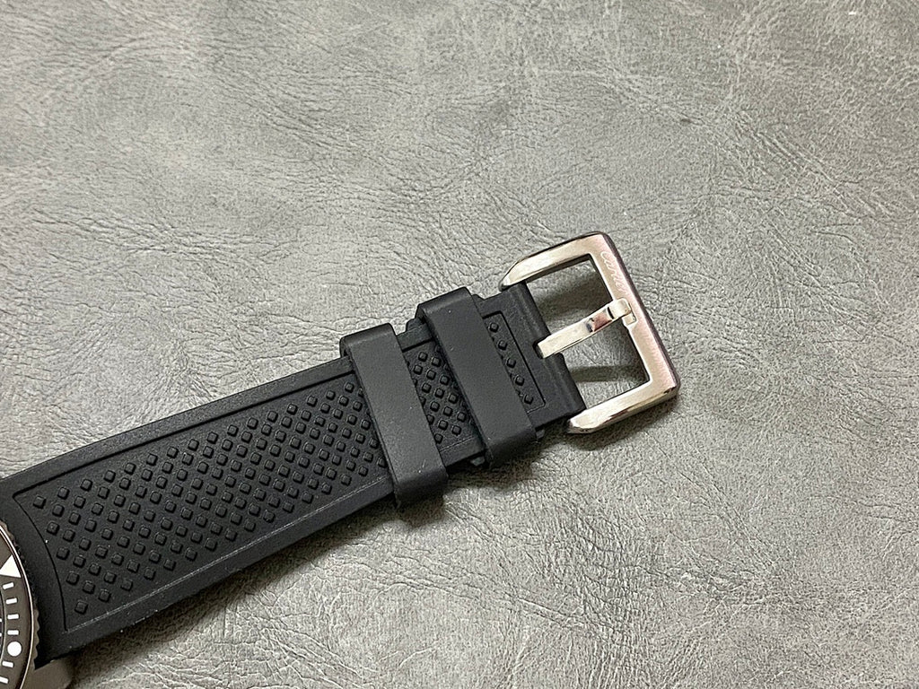 Cartier watch with black textured rubber strap and silver clasp buckle