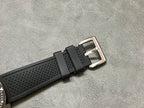 Cartier watch with black textured rubber strap and silver clasp buckle