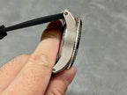 Cartier watch side profile with stainless bezel and textured black rubber strap