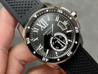 Cartier watch with black dial, Roman numerals, date window, and black rubber strap