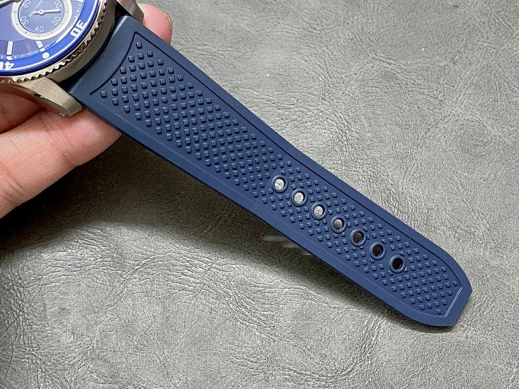 Textured blue silicone watch strap with small circular grip dots and perforations