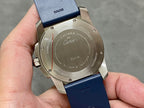 Stainless steel watch case back with engraved text and blue silicone strap