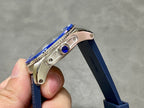 Blue jeweled crown and stainless steel case with ridged bezel on blue silicone strap