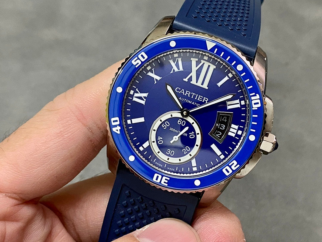 Blue dive-style watch with Roman numerals, subdials, and textured silicone strap
