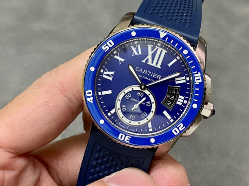 Blue dive-style watch with Roman numerals, subdials, and textured silicone strap