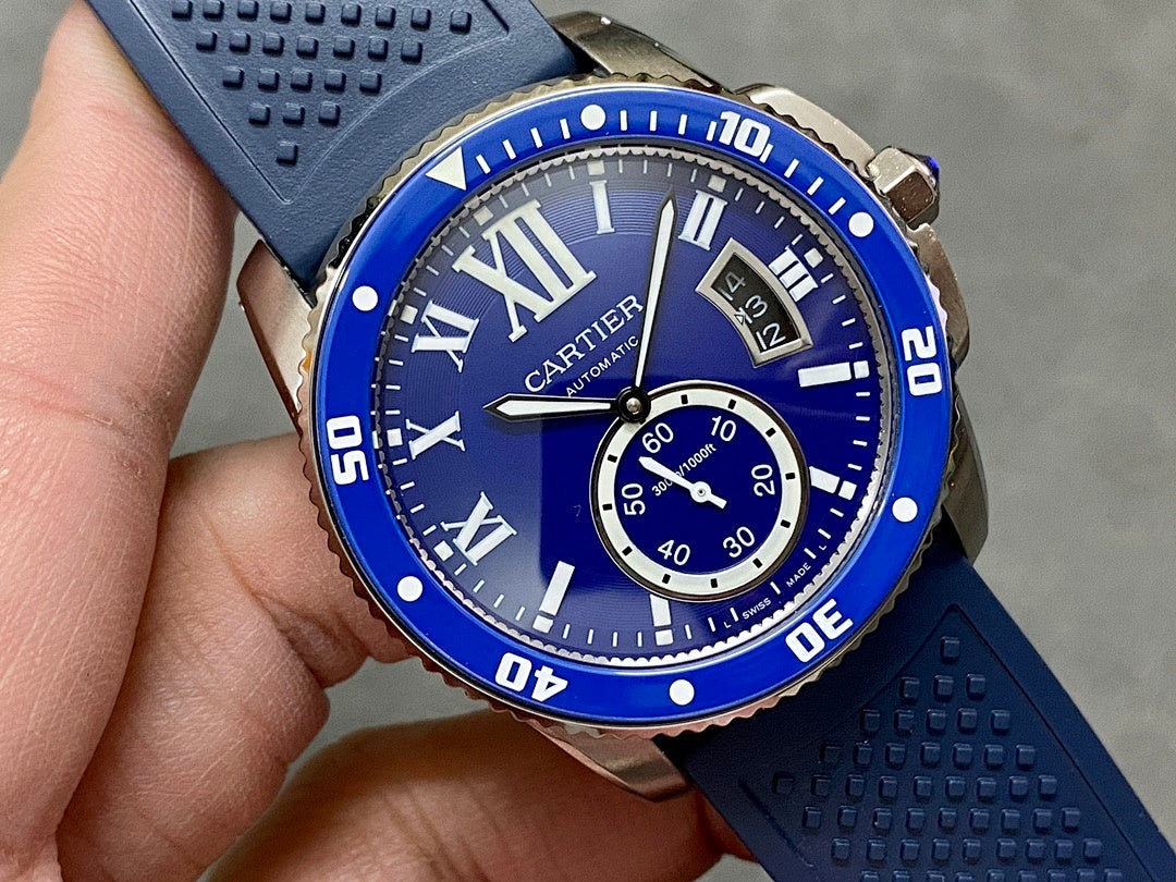 Blue watch face with Roman numerals, subdial, and minute track on silicone strap