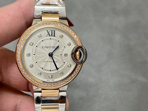 Gold and silver wristwatch front view with white dial, Roman numerals, jeweled bezel