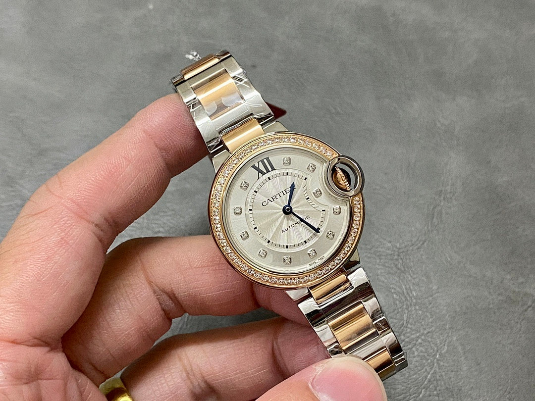 Gold and silver wristwatch with white dial, blue hands, and jeweled bezel