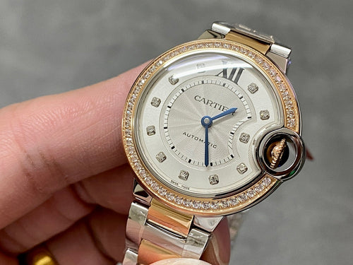 Gold and silver wristwatch with jeweled bezel and white dial, blue hands