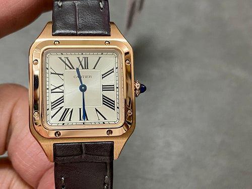 Cartier wristwatch front view: rose gold square case, white dial with Roman numerals, blue hands, black strap