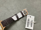 Cartier wristwatch buckle and strap: rose gold case end with black leather strap and paper tags