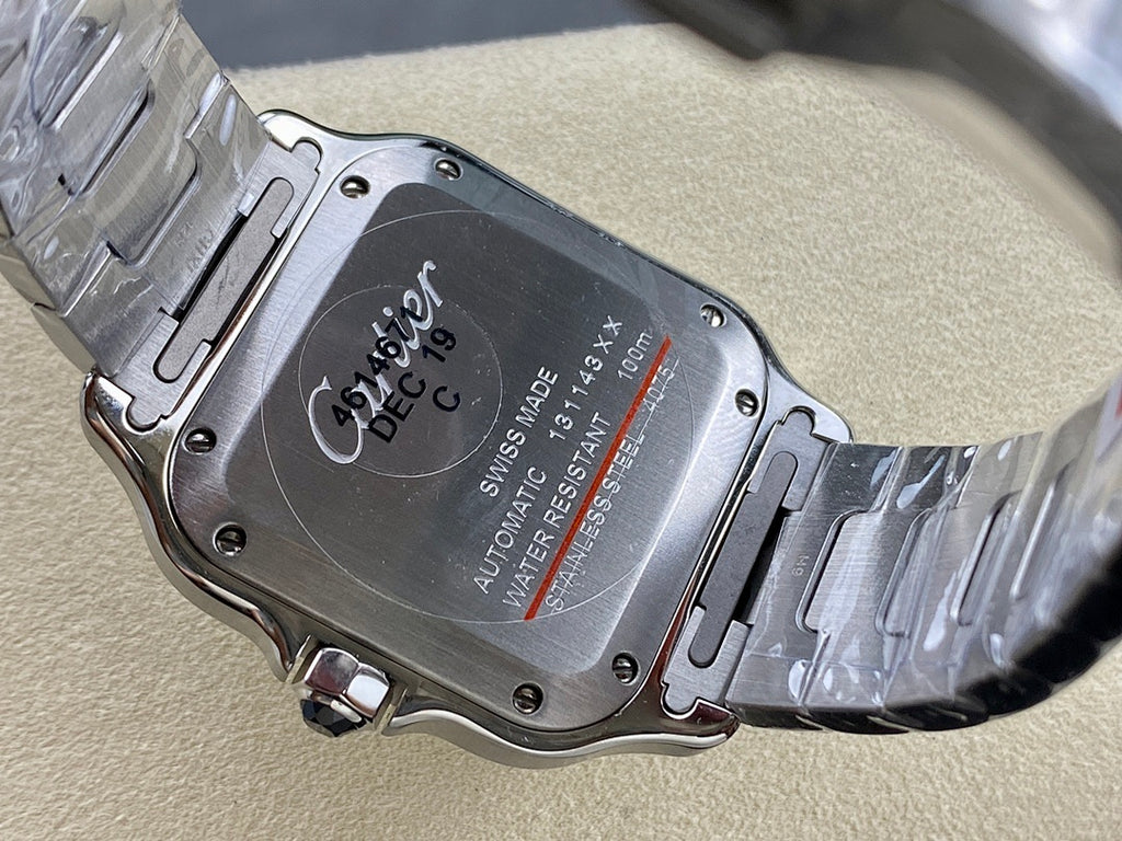 Stainless steel watch case back with engraved markings and bracelet link details