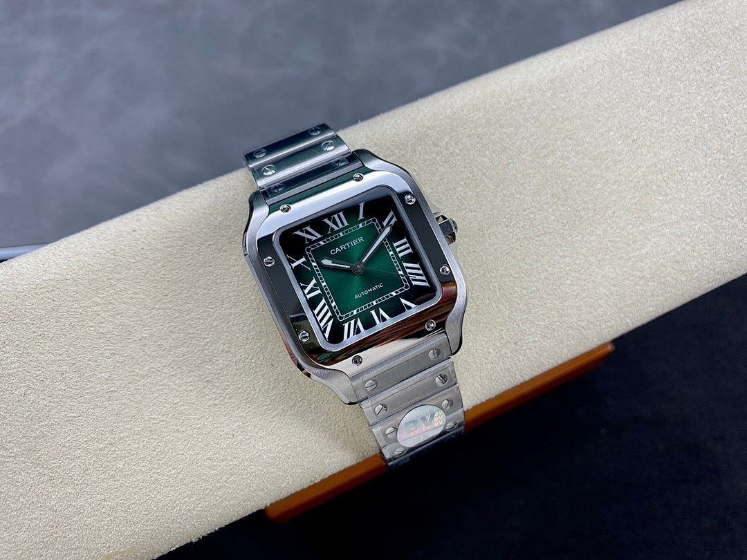 Stainless steel wristwatch with green dial on bracelet, angled view on cushion