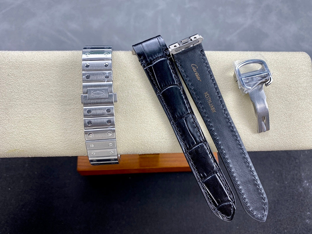 Cartier watch accessories: steel bracelet, black leather strap, and metal key on cushion