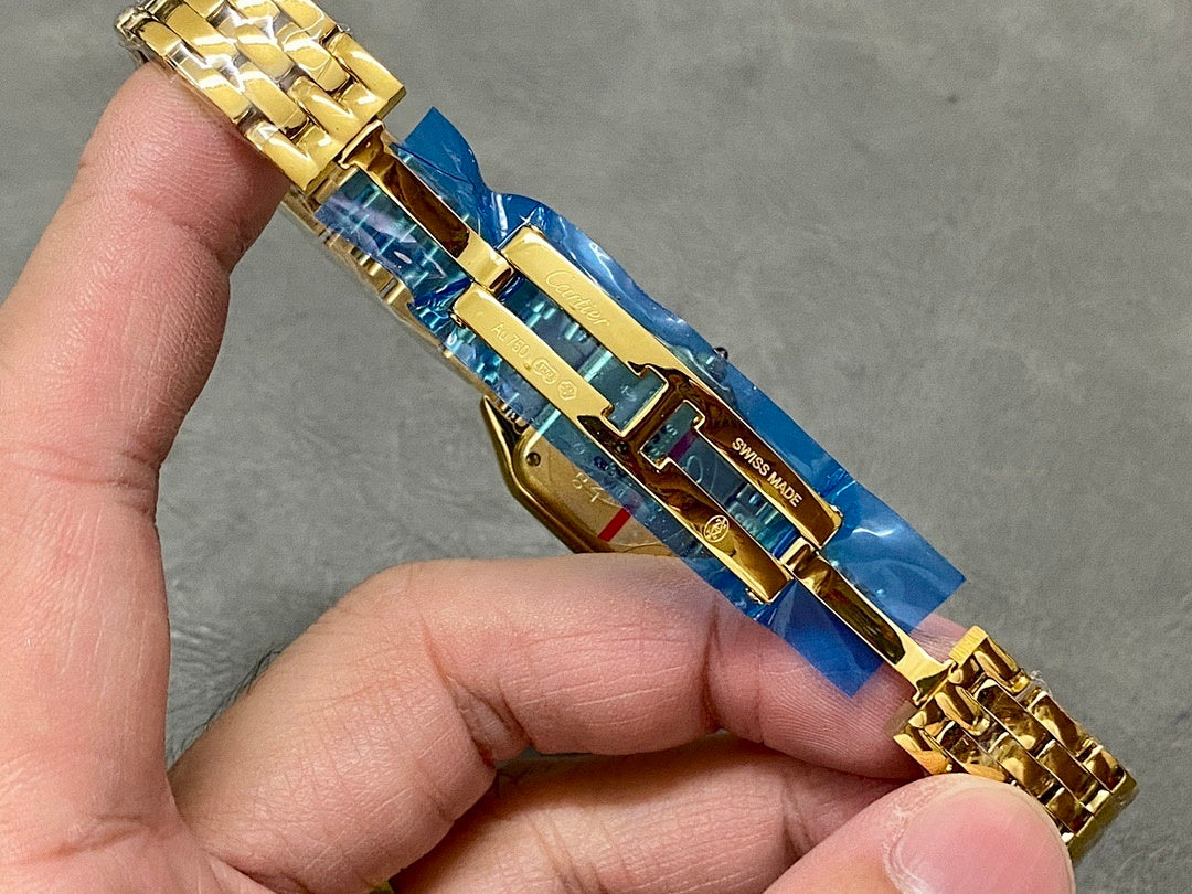 Gold-tone Cartier wristwatch bracelet detail with blue strap and engraved markings
