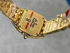 Gold-tone Cartier wristwatch case back with engraved markings and crown