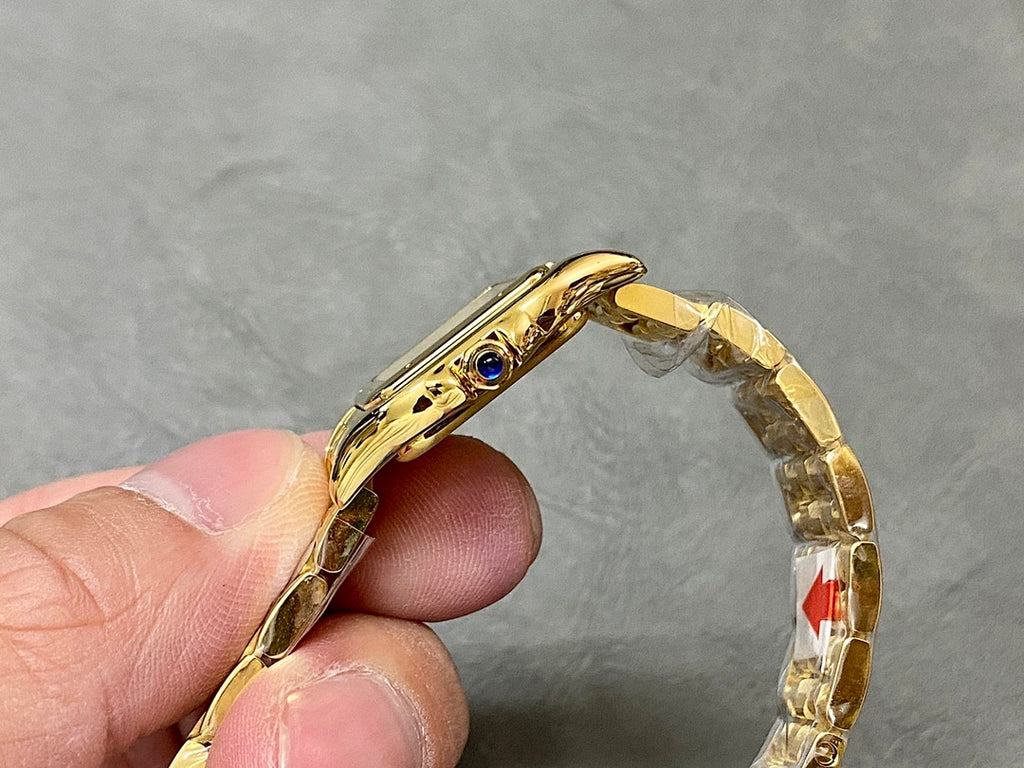 Gold-tone Cartier wristwatch angled view showing bezel and side crown