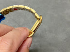 Gold-tone Cartier wristwatch bracelet end with clasp area