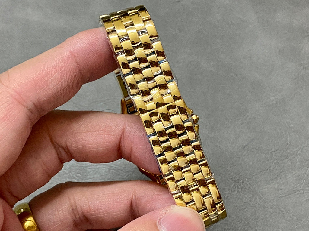 Cartier watch gold link bracelet on hand, square case with bezel detail