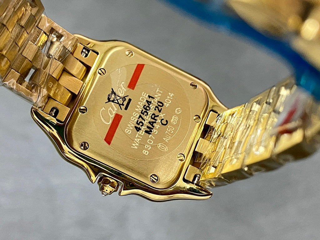 Cartier watch case back with engraved markings and Swiss cross emblem