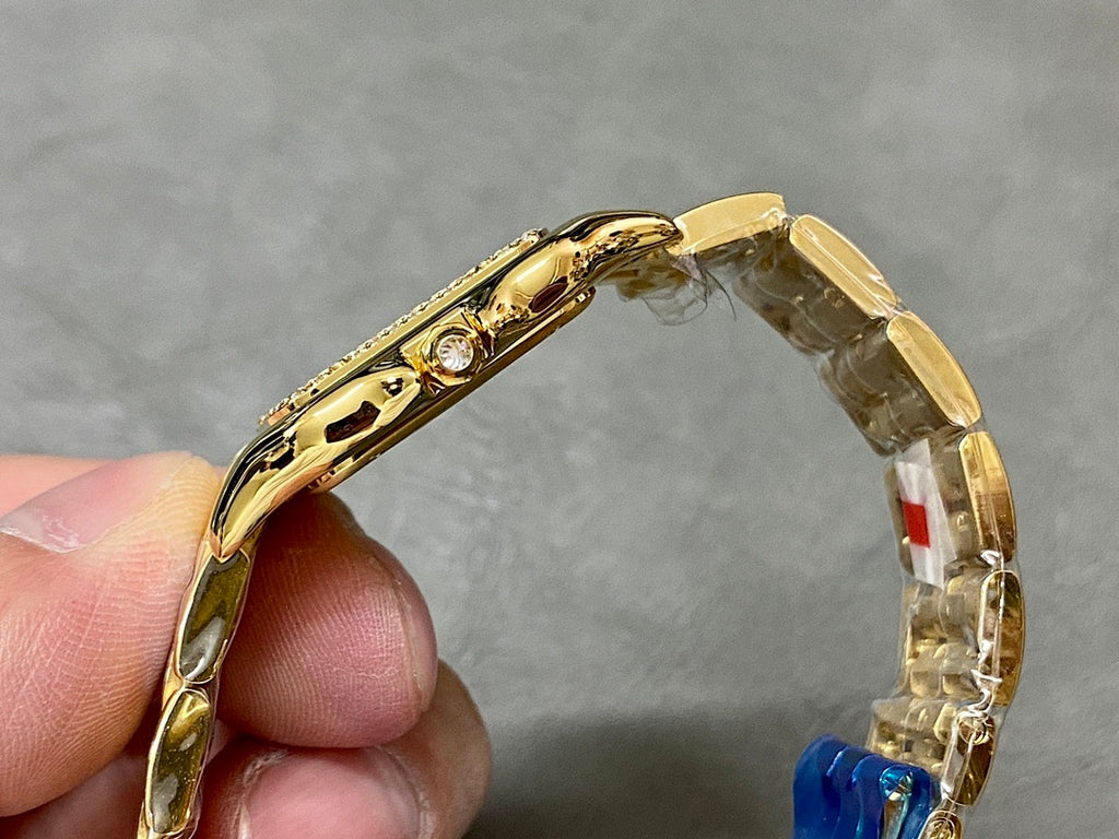Cartier watch side view with gold case and crown near top edge
