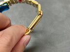 Cartier watch angled side view showing gold case curve and bracelet links