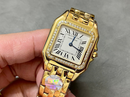 Cartier watch with square gold case, Roman numeral dial, and gold link bracelet