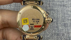 Gold Cartier watch back with engraved case, serial markings, blue leather strap underside.