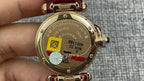Cartier wristwatch case back with gold finish and red leather strap