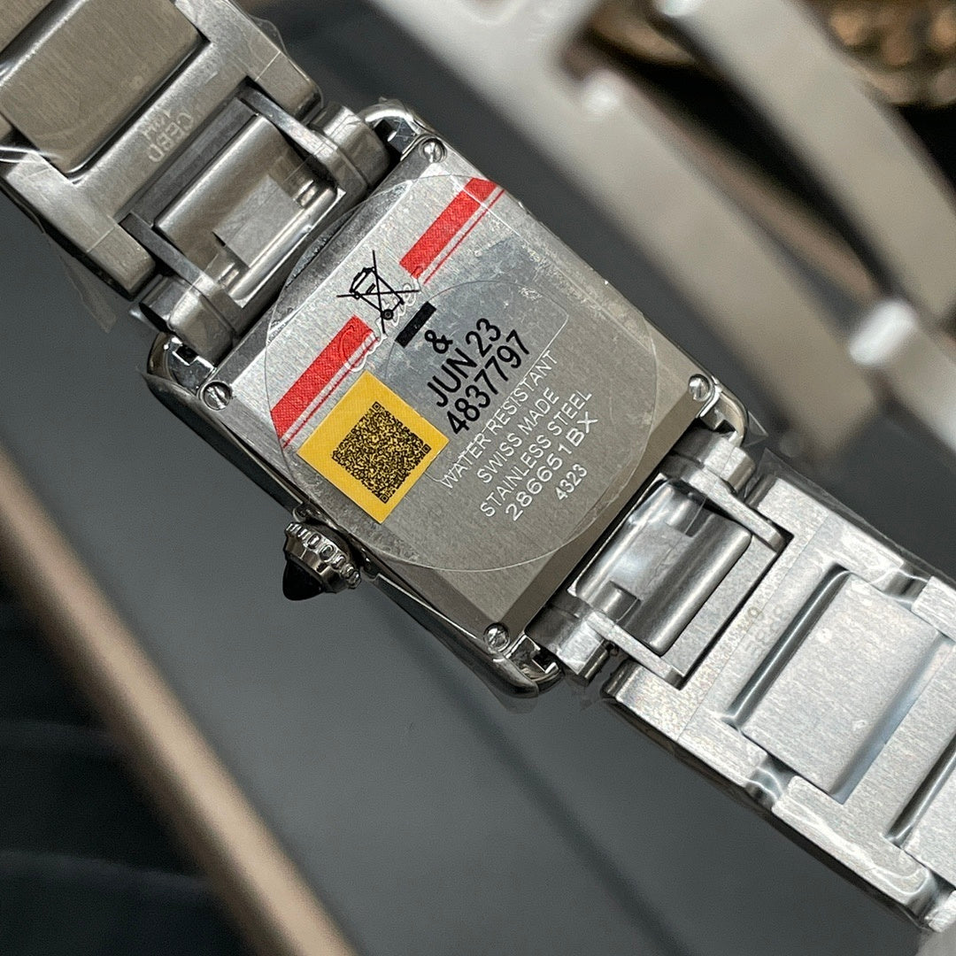 Cartier watch case back with silver-tone bracelet, barcode label visible