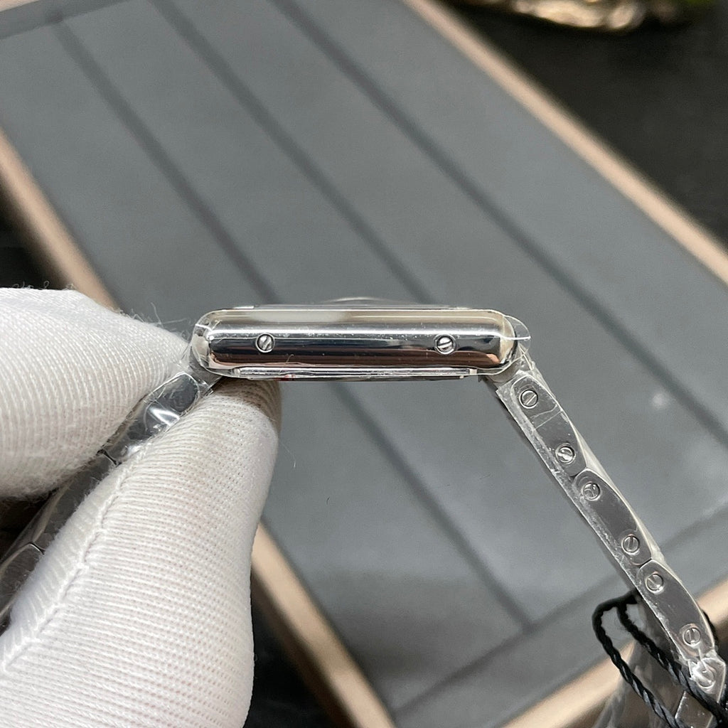 Cartier watch crown and case edge, silver-tone metal, close-up