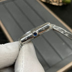 Cartier watch side profile with blue jewel detail on silver-tone case