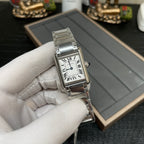 Cartier watch angled view with silver-tone bracelet and white dial