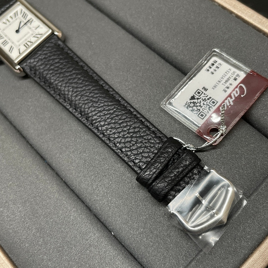 Cartier wristwatch strap close-up with silver buckle clasp and product tag on black leather.