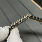 Cartier wristwatch side view with blue detail on the case and black leather strap.