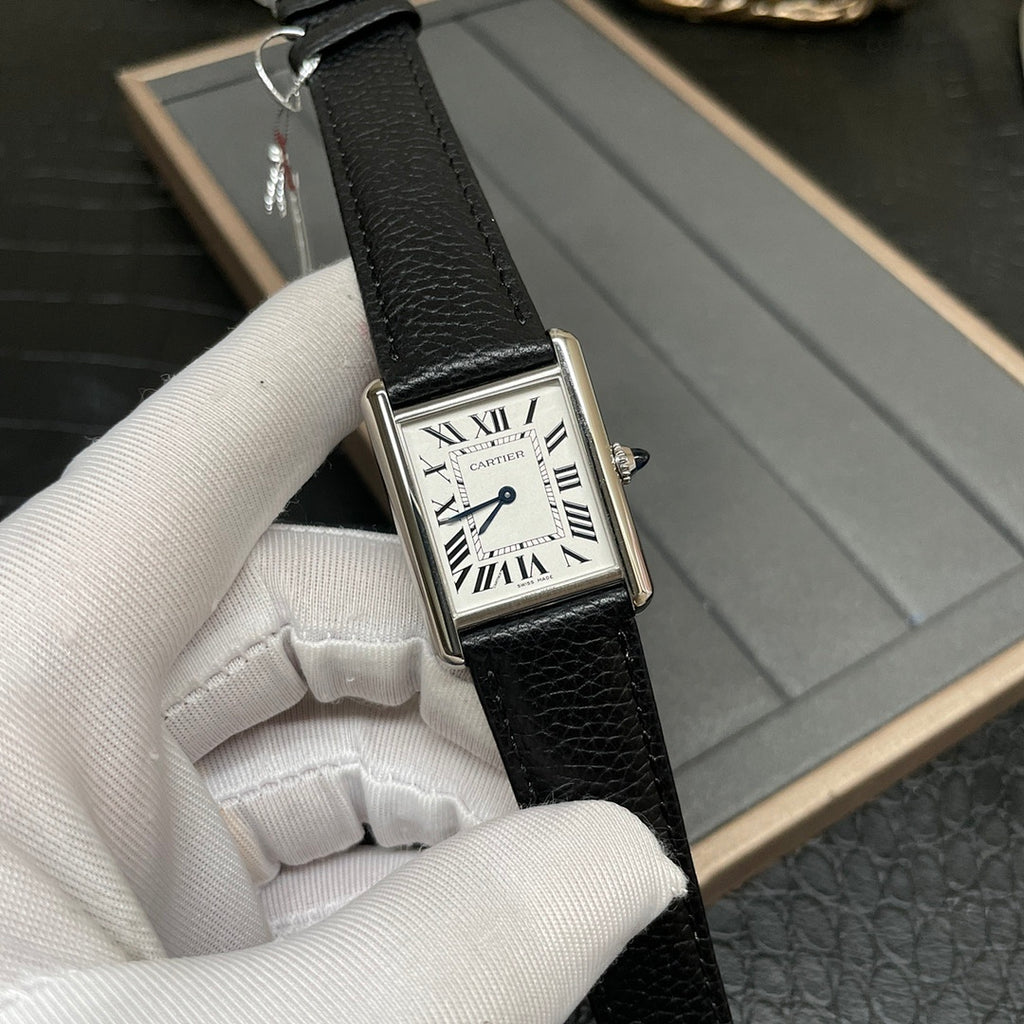 Cartier square wristwatch front view with white dial, Roman numerals, and black leather strap.